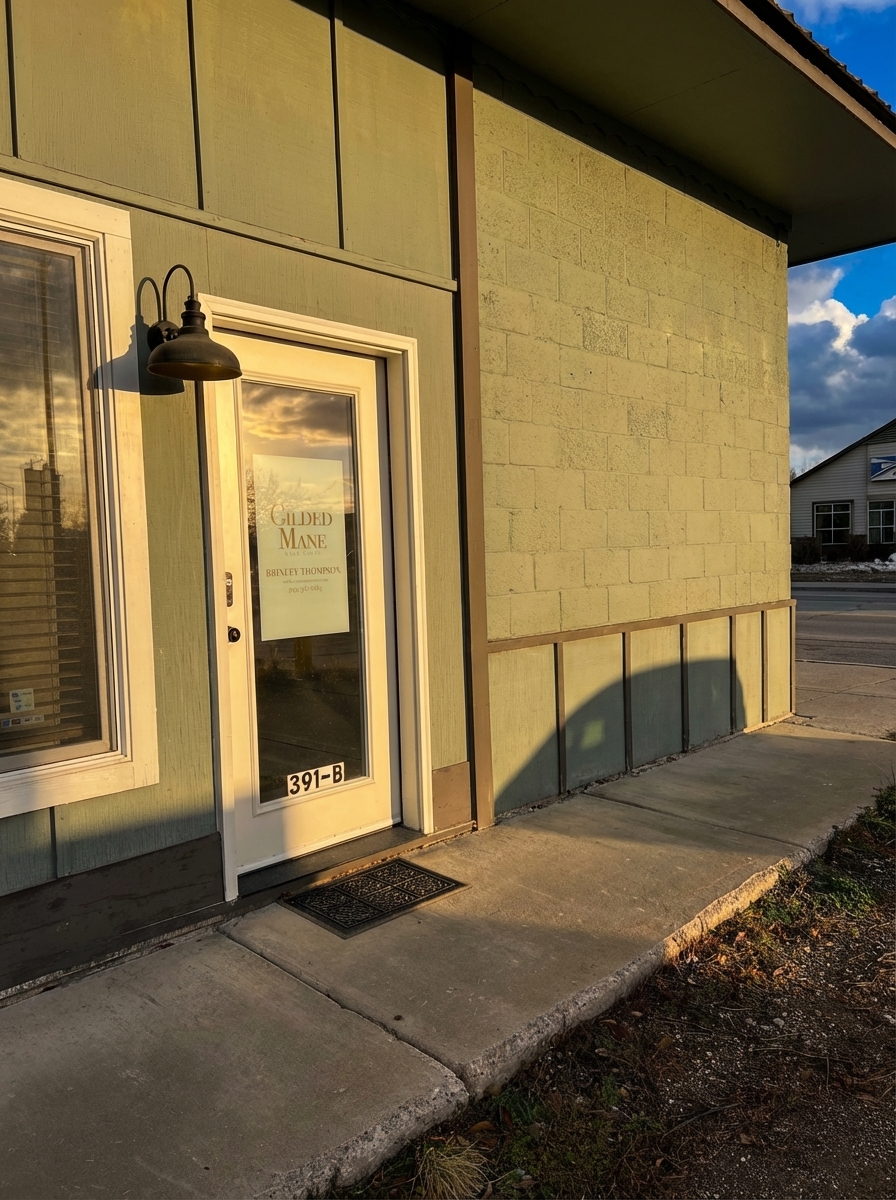 Gilded Mane salon entrance - Suite 391-B with glass door and vintage lamp