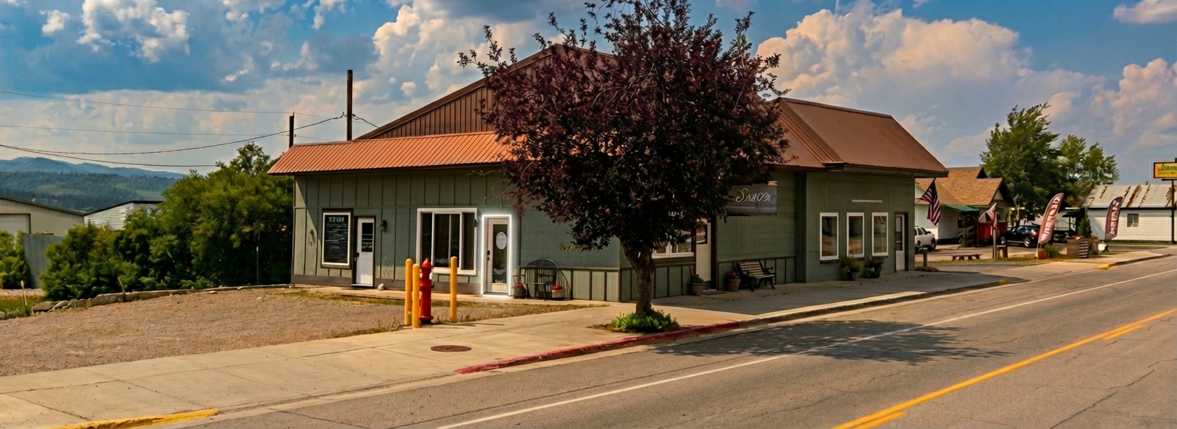 Gilded Mane salon building - green building with brown metal roof on Main Street in Thayne, Wyoming